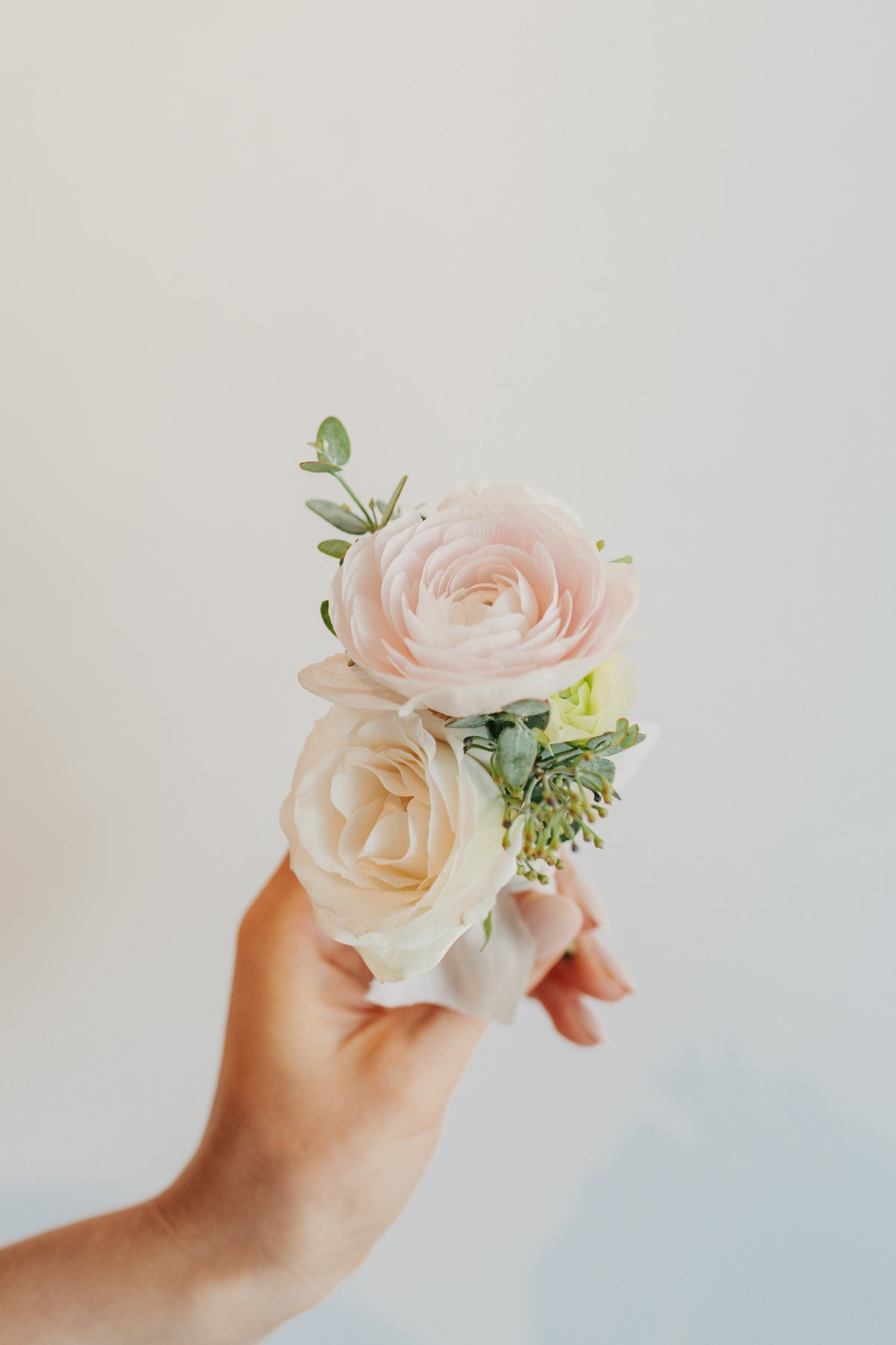 A bride holds a Wedding Boutonnière - Columbia, Tennessee - Wedding Flowers by Bloomstall Flower Boutique in Columbia, Tn