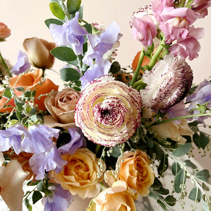 Detail image of ranunculus flowers in a flower arrangement.