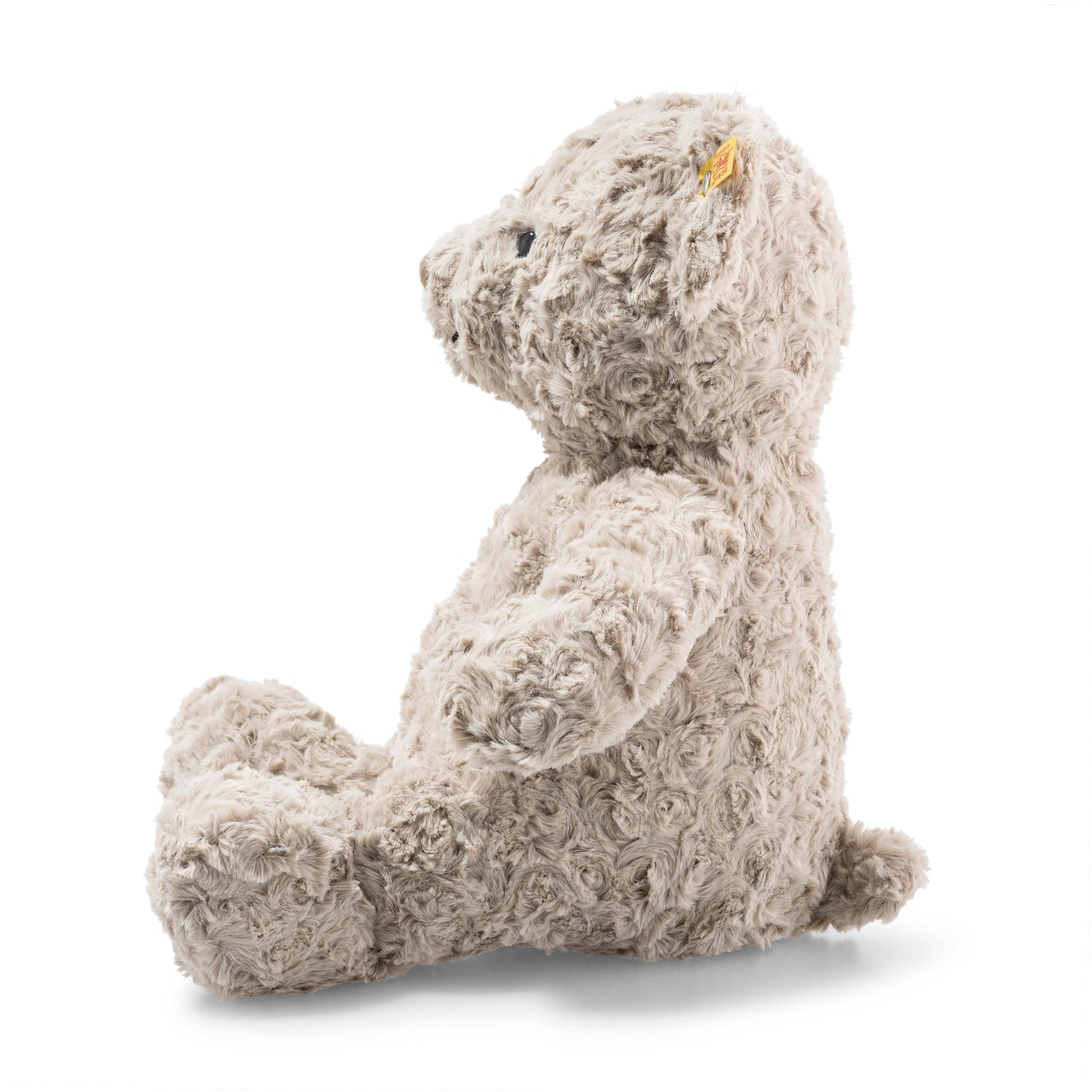 Plush teddy bear with a tag on a white background