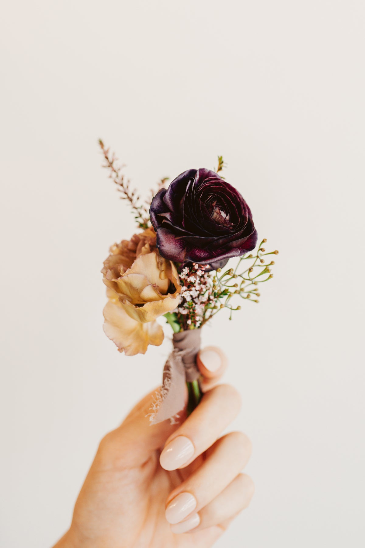This image shows a moody color scheme boutonniere from bloomstall